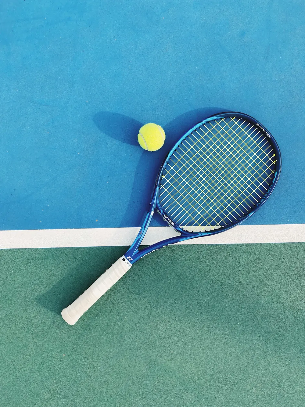 Tennis racket and ball resting between points